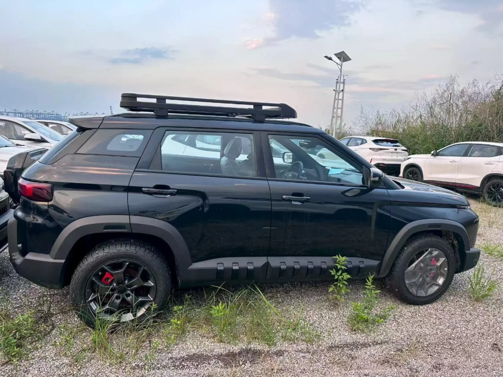 Geely Cowboy 2026 1.5 Explore Edition side profile showing rugged cladding, red brake calipers and roof rack